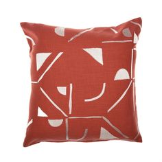 a red and white pillow with an abstract design