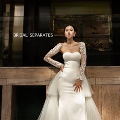 a woman in a white wedding dress posing for the camera