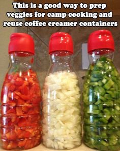 three bottles filled with different types of vegetables on top of a counter next to each other