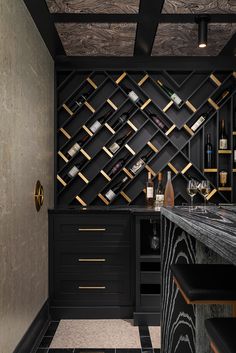 a black and gold bar with wine bottles on the shelves