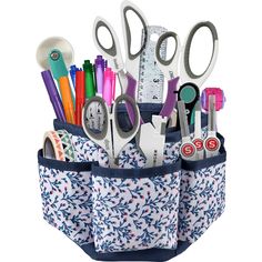 scissors, pens, markers and other office supplies in a blue pocket on a white background