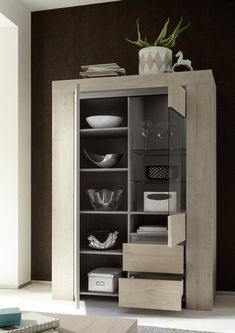 a cabinet with glass doors and drawers in a living room