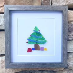 a paper christmas tree in a shadow box frame