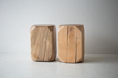 two wooden stools sitting next to each other on a table