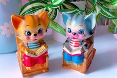 two little kitten figurines sitting next to each other