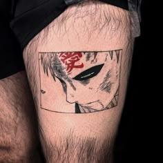 a man's leg with an anime character tattoo on the side of his thigh