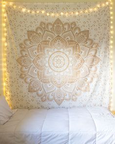 two pictures of a bed with lights on the headboard and an image of a wall hanging above it