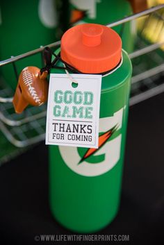 an orange and green sports bottle with a good game tag hanging from it's side