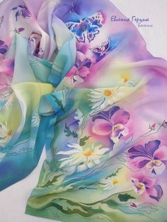 an image of a scarf with flowers and butterflies on the front, in pastel colors