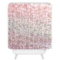 a shower curtain with pink and silver glitters on the outside, in front of a white