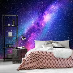 a bedroom with purple and blue galaxy wallpaper