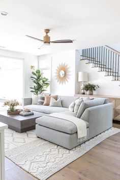 a living room filled with furniture and a staircase