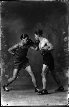 an old photo of two men boxing