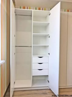 an empty white closet with drawers and shelves