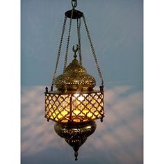 a chandelier hanging from the ceiling with clouds in the background