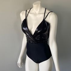 This Swimsuit Is Black And Has A Faux Leather Top With A Plunging Neckline. My Mannequin Isn’t Very Blessed On The Backside So It’s Hard To Tell But It’s Got A Cheeky Cut On The Bottom. Super Fun For A Festival, Pool Party, Or Just To Have A Unique, Eye Catching Swimsuit. New With Tags And Hygienic Liner Still Intact. Chic Party Bodysuit With Lined Body, Sleek Backless Bodysuit For Parties, Sleek Evening Bodysuit With Lined Body, Lined One-piece Bodysuit For Party, Chic Party Swimwear Lined, Triangle Top Bodysuit For Club With Lined Body, Triangle Top Bodysuit With Lined Body For Club, Triangle Top Lined Bodysuit For Club, Triangle Top Bodysuit For Night Out