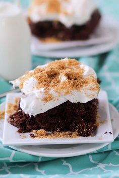 there is a piece of cake on the plate with whipped cream and chocolate shavings