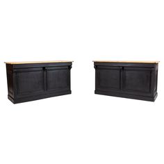 two black cabinets with wooden top on white background