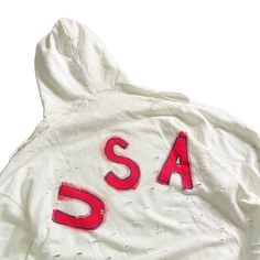 DESCRIPTION EACH PIECE IS MADE TO ORDER, HAND PAINTED BY GLORIA AND HER TEAM IN THEIR NYC STUDIO PRODUCT DESCRIPTION The perfect oversized white distressed hoodie. American flag painted on front chest, with USA painted on back in red, with blue outline. Signed @wrenandglory Due to each piece being hand painted, each piece might have slight differences. Limited edition. FIT Oversized, Super Comfy, Slouchy fit. Can be worn as a sweater or dress. One size fits most Measurements: Body Width 27", Len White Distressed Casual Sweatshirt, White Distressed Sweatshirt For Fall, White Distressed Long Sleeve Outerwear, Distressed Cotton Hooded Tops, White Distressed Sweatshirt, White Distressed Long Sleeve Sweatshirt, Oversized Distressed Cotton Hoodie, Distressed Cotton Hoodie, Distressed White Long Sleeve Top