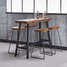 a wooden table with four stools in front of it