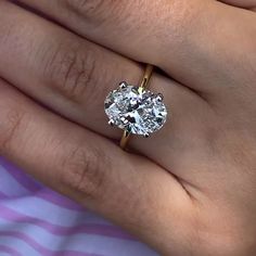 a woman's hand with a diamond ring on it