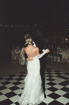 the bride and groom are dancing on the dance floor