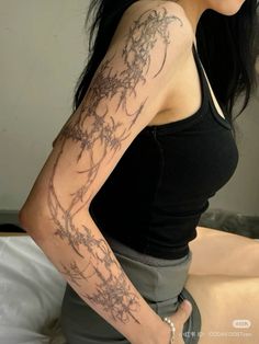 a woman with a tattoo on her arm