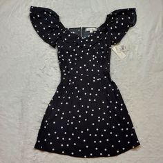 Rowa Black White Polka Dot Mini Dress Size Xs New With Tags! Ruffle Sleeves Have Elastic And Can Be Worn Off Shoulder. All Measurements Are Photographed, So Please Check The Photos To See Dimensions. Color Of Item May Appear Slightly Different In Photos Depending On Lighting And Phone Settings. Comes From A Smoke-Free, Pet Friendly Home. New To Poshmark? Use My Invitation Code Melodicrose For $10 Off Your First Purchase When You Sign Up! Bundle To Save $$$! Follow My Closet For New Listings! Hap Cute Fitted Black Mini Dress, Casual Polka Dot Mini Dress With Short Sleeves, Polka Dot Mini Dress, Strappy Mini Dress, Embroidered Lace Dress, Flutter Dress, Mod Cloth Dresses, Midi Wrap Dress, Pleated Mini Dress