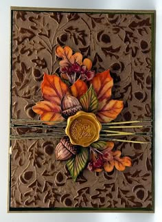 a close up of a greeting card with flowers and leaves on the front, featuring a wax stamp that reads joy you