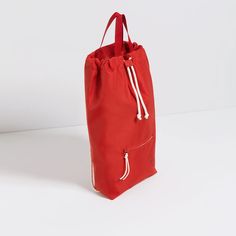 a red bag sitting on top of a white table