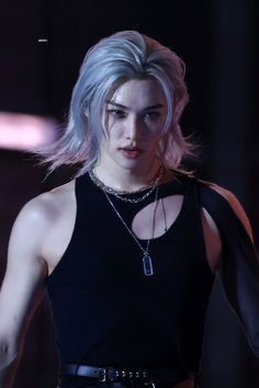 an image of a woman with blonde hair and piercings on her chest, wearing a black top