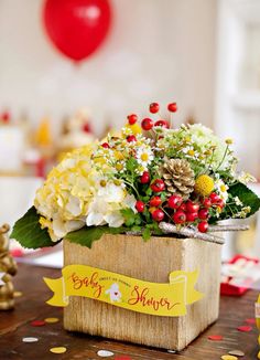 a wooden box filled with flowers on top of a table