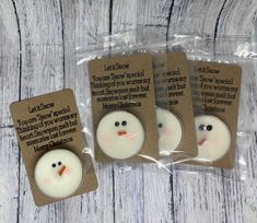 three little snowmen are in plastic bags