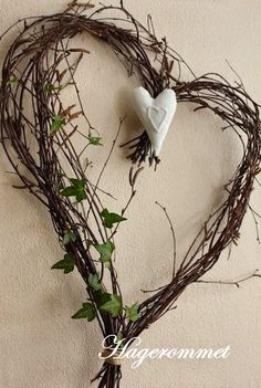 a heart shaped wreath with vines and flowers