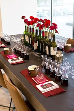 the table is set with wine bottles, glasses and other items for an elegant celebration