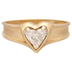 Love is in the air! With this 14k gold engagement ring, express your love with a heart-shaped diamond weighing approximately .58-ct., and graded G-H color and VS-SI. Set in a polished heart frame with a tapering satin band, the ring harks back to the 1950's era of love and optimism. The ring weighs 3.1 grams, and is currently size 8, with easy up/down adjustment. A ring of pure romance! Antique Sapphire Engagement Rings, Vintage Sapphire Engagement Rings, Heart Shaped Diamond Ring, Heart Shaped Engagement Rings, Easy Up, Sapphire Engagement Rings, Heart Engagement Rings, Diamond Heart Ring, Pure Romance