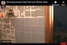 a person is using a tiler to remove wall tiles from the shower area in a bathroom