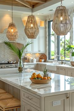 a large kitchen island with some fruit on it and lights hanging from the ceiling above