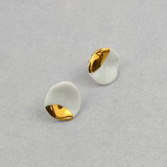 These earrings are a smart-casual choice, not too big for office but still sparkling enough for a special day or a night out. They are made from white porcelain. Each product is handmade and painted, which makes it unique. They have stainless steel studs and are decorated with 24K real gold. Product Info: Size: 2 x 2 cm (0.78 x 0.78 in) Comes in a nice-looking gold paper bag, ready to be gifted Other ceramic jewelry, brooches and stud earrings are available in my etsy shop: www.etsy.com/uk/shop/ Modern White Earrings For Anniversary, Modern White Earrings For Formal Occasions, White Round Plug Earrings For Formal Events, White Round Plug Earrings For Formal Occasions, Formal White Drop Earrings, Minimalist White Plug Earrings As Gift, Earrings For Wedding, Earrings Bride, Cat Lady Gift