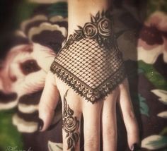 a woman's hand with an intricate lace design on the top and bottom of it