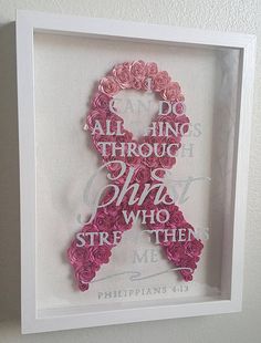 a pink ribbon made out of flowers in a white frame