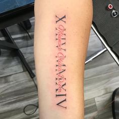 a person with a tattoo on their arm that reads x, y and the other letter is in cursive writing