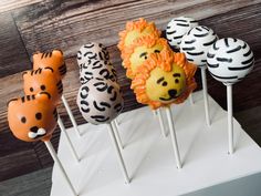 four cake pops decorated like animals and zebras