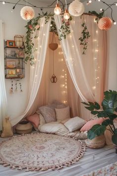 a room with lights and plants on the ceiling, curtains over the bed are open