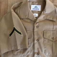 "This is a Vintage Marine Uniform Shirt circa 1980's Men's Size Length: 29\" Chest: 42\" All buttons are included and no obvious holes or stains. 75% Polyester 25% Wool Very Good condition! Please feel free to contact me with any questions. I am happy to help :)" Retro Khaki Button-up Shirt, Vintage Khaki Shirt With Button Closure, Military Style Collared Shirt With Snap Buttons, Vintage Khaki Tops With Snap Buttons, Vintage Short Sleeve Button-up Shirt, Vintage Military Uniforms, Marines Uniform, Uniform Shirts, Military Patch