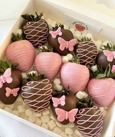 chocolate covered strawberries in a box with pink bow ties and bows on the top