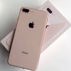 two iphones sitting next to each other on top of a white surface with the back facing up