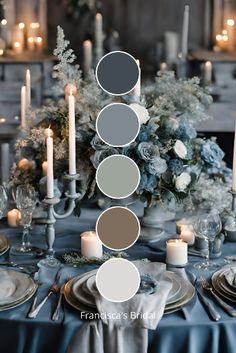 the table is set with candles, plates and flowers in shades of blue gray and white