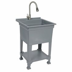 a gray sink sitting under a faucet next to a faucet on a white