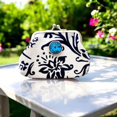 a white and black purse sitting on top of a table